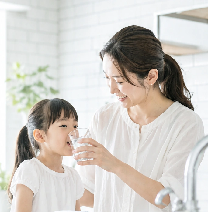 お母様に見守られながら水を飲むお子様